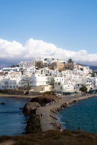 White houses in front of sea against sky in old town