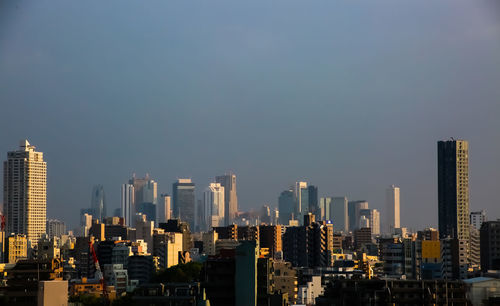 Modern buildings in city against sky