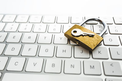 Close-up of padlock and key on keyboard