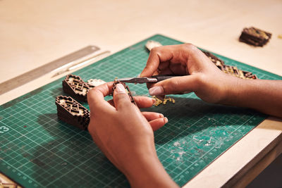 High angle view of woman hand on table