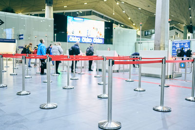 Rear view of people walking at airport