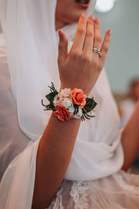 Midsection of woman holding flower bouquet