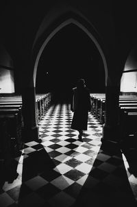 Rear view of woman walking in corridor