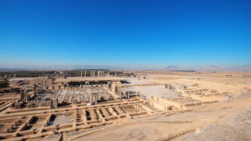 Aerial view of persepolis, ancient capital of persian empire against blue sky