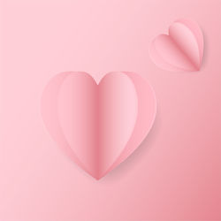 Directly above shot of heart shape over pink background