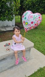 High angle view of cute girl playing with balloons