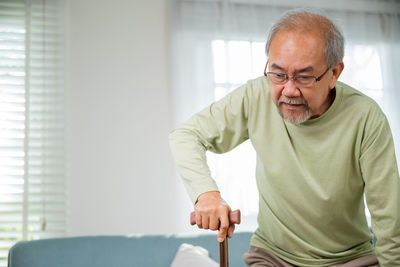 Portrait of senior man working at home