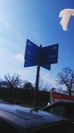 Road sign against blue sky