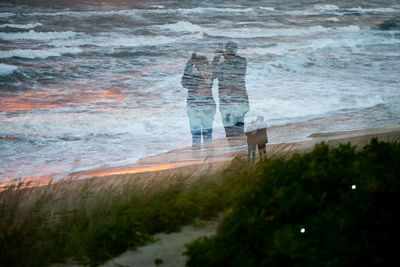 People on beach by sea