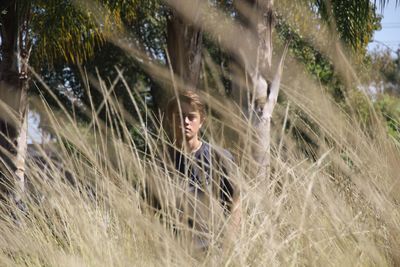 Woman standing on tree trunk