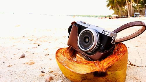 Close-up of camera on beach