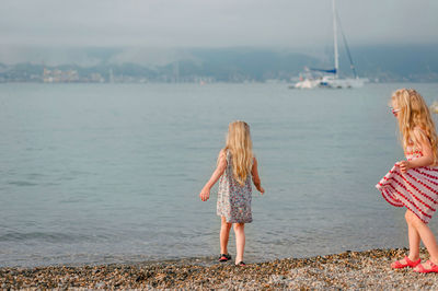 Rear view of women against sea