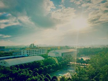 View of cityscape against cloudy sky