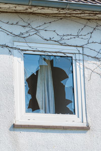 Low angle view of window in abandoned building