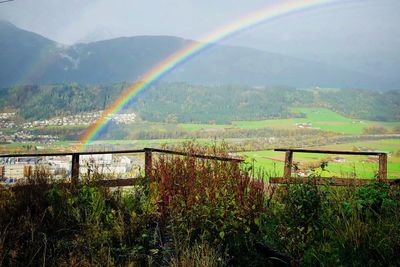 Scenic view of rainbow over mountain against sky