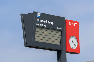Low angle view of information sign against clear sky