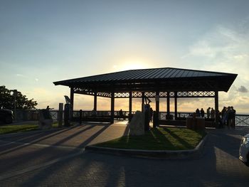 People by gazebo during sunset