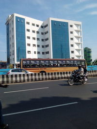 View of vehicles on road along buildings