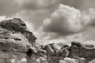 Low angle view of rock formation against sky