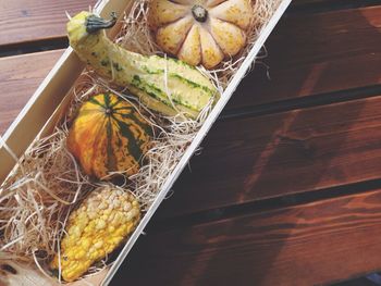 High angle view of pumpkins in basket on table