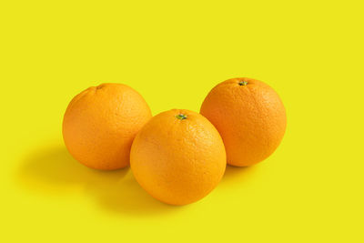 Close-up of oranges against orange background