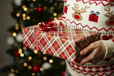 Midsection of woman holding christmas tree