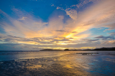 Scenic view of beach against sky during sunset