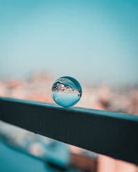 Close-up of crystal ball on railing