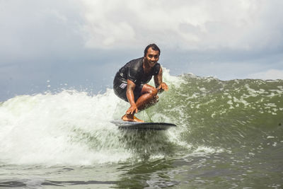 Full length of man in sea against sky