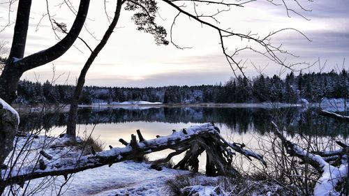 Scenic view of frozen lake against sky during winter