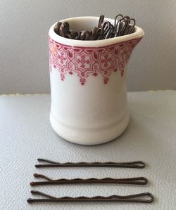 Close-up of hair clips on table