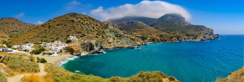 Panoramic shot of sea and mountains against sky