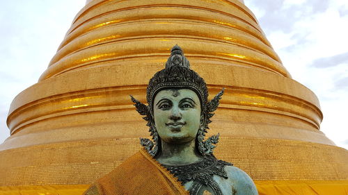 Low angle view of statue against temple building