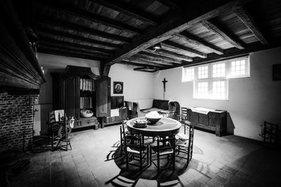 Empty chairs and tables in building