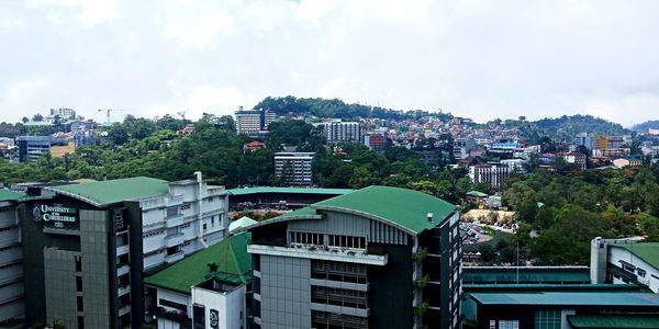 High angle view of buildings in city against sky