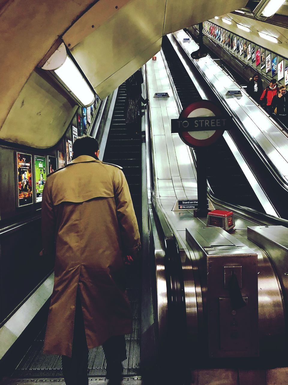 REAR VIEW OF MAN STANDING ON TRAIN