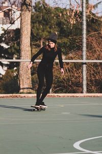 Full length of woman skateboarding at playground
