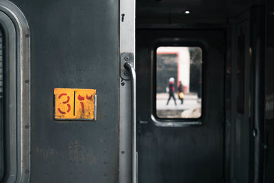 Interior of train seen through door