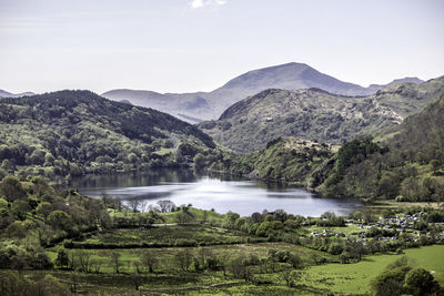 Scenic view of lake and mountains against clear sky