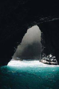 Scenic view of sea seen through cave