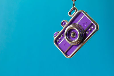 Close-up of clock tower against blue background