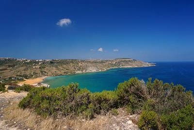 Scenic view of sea against blue sky