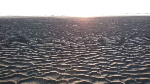 Scenic view of beach against sky during sunset