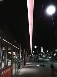 Illuminated street lights in city at night