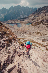 Scenic view of a person climbing a rock face