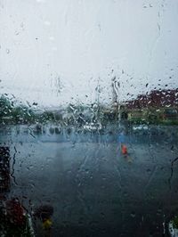 Full frame shot of wet glass window during rainy season