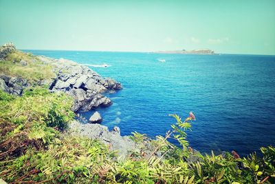 Scenic view of sea against blue sky