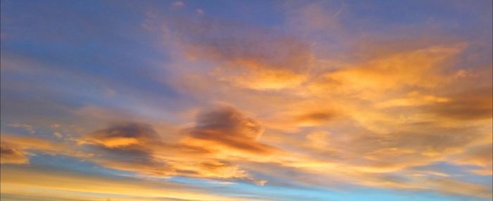 Low angle view of cloudy sky at sunset