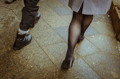 Low section of people standing on sidewalk