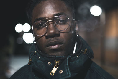 Close-up portrait of young man at night